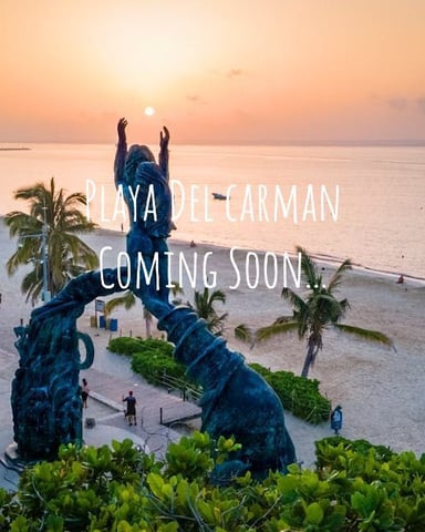 Large blue sculpture of hands on beach at sunset with palm trees and calm ocean water, text overlay reads Playa del Carmen Coming Soon